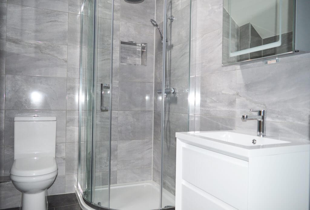 A bathroom interior with a new shower and sink